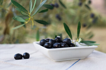 black ripe olives on plate on table in olive garden