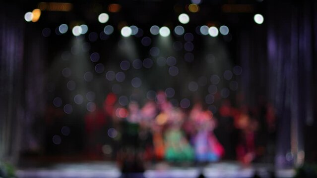 Blur defocus texture, background for design. Singers and musicians perform on scene.