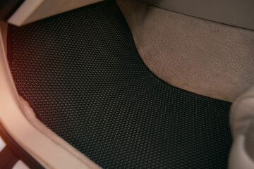 Driver-side black floor mats made of ethylene vinyl acetate shortened for EVA. Dark floor mats in...