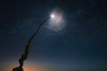Spaceship rocket with a column of smoke successfully launch into the starry sky. Space shuttle...