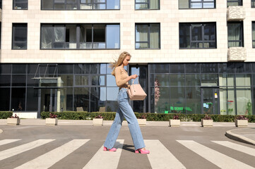 A beautiful girl crosses a pedestrian crossing.