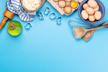 Cooking ingredients and utensils on blue background
