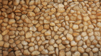 A wall of round cobblestones in concrete. Home Design Decision.Round Cobblestone Wall Texture. Home design conception