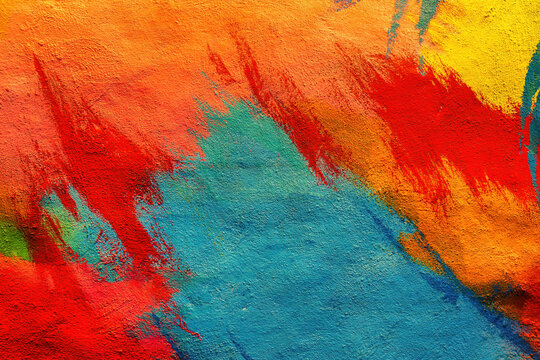 Colorful graffiti painted on a wall. Abstract urban background. Spray painting art. © Eugene_Photo