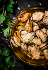Pickled mussels in a bowl with parsley. 