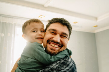 Happy father hugging son at home