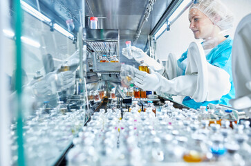 Female scientist working in cleanroom of a microbiological lab