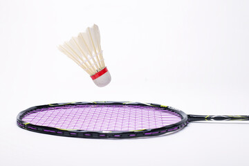 shuttlecock and badminton racket isolated white background