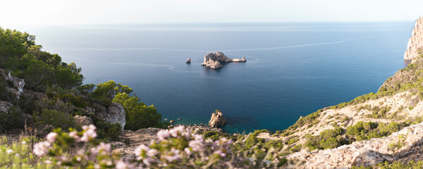 Spain, Balearic Islands, Panoramic view of Ses Margalides rock arch and surrounding sea seen from coastal clifftop
