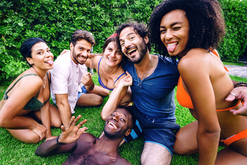 Multiethnic Summer Fun: Group of friends taking a candid selfie in the backyard