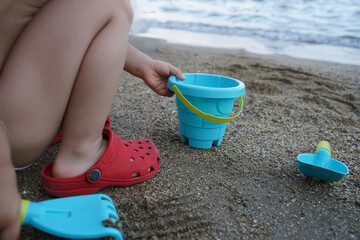 Belek, Turkey - 09.23.202: Child plays on the beach close-up. Selective focus, blurred background