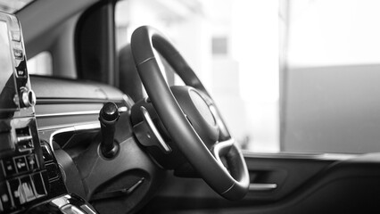 Close-up at steering wheel and controlling dashboard of the modern design car, ready for driving...