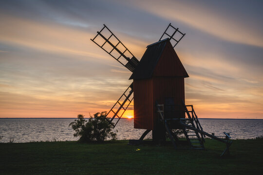 Sweden, Oland, Morbylanga, Coastal windmill at sunset