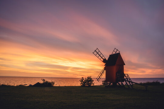 Sweden, Oland, Morbylanga, Coastal windmill at sunset