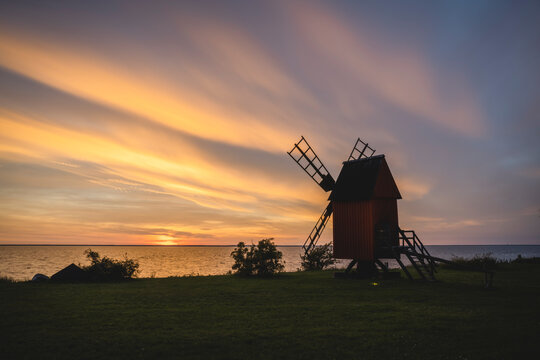 Sweden, Oland, Morbylanga, Coastal windmill at sunset