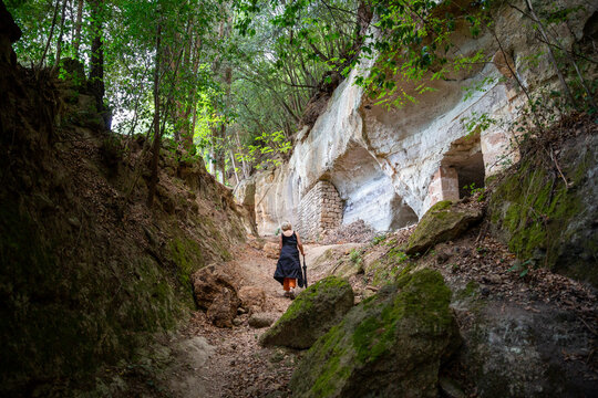 Active senior woman walking amidst rocks
