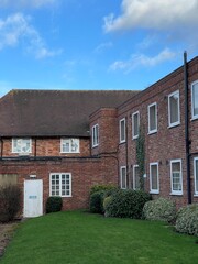 Cozy brick apartment building with green grass in the yard