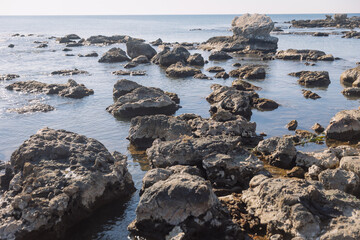 Fototapeta na wymiar Rocks on beach in the morning, calm and natural background