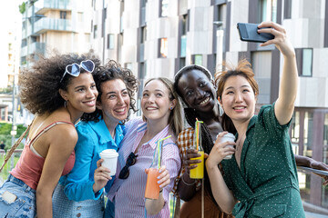Group of female friends taking selfie picture smiling at camera, smiling young girls celebrating standing outside and having fun, portrait photography of teenagers girls enjoying vacation