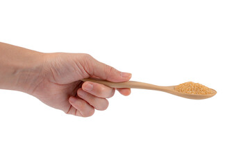 Hand and brown sugar on wooden spoon on a transparent background.