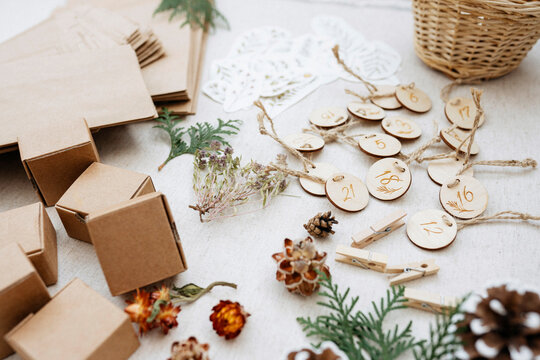 Various materials and cardboard boxes for Christmas advent calendar on carpet