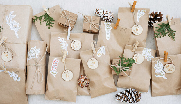 Decorated paper bags with pine cones and cardboard boxes on carpet