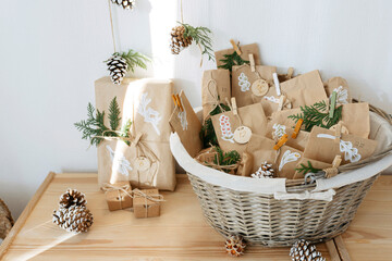 Decorated brown paper bags kept in basket for DIY advent calendar