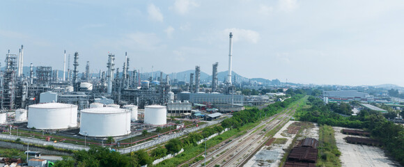 Obraz premium Oil Refinery Gas Chemical Equipment Prodiction import export Concept, Crude Oil Refinery Plant Steel Pump Pipe line and Chimney and Cooling tower, Chemical or Petrochemical Factory plant, industry