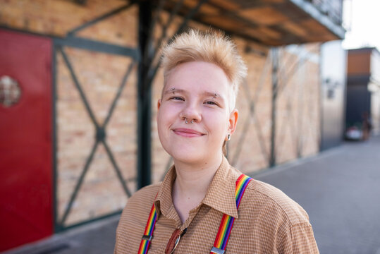 Smiling non-binary person wearing nose ring on street