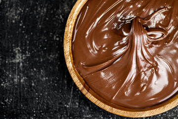Wooden plate with hazelnut butter. 