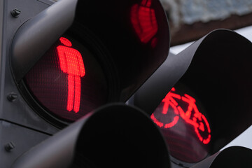 Red traffic light for pedestrians and people with bikes showing that they are not allowed to cross...