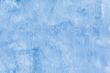 Texture of winter ice on a stone cliff. Blue natural ice background