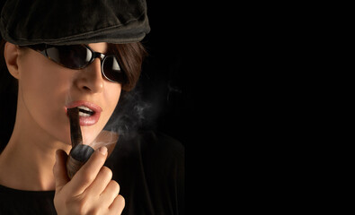 Atractive young woman smoking a vintage wooden pipe