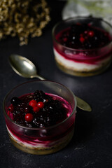 Glasses with a dessert of cheesecake with berries jam