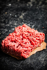 A piece of raw minced meat on paper. 