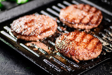 Grilled burger in a frying pan. 