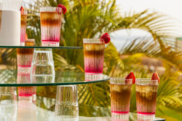 cold cocktail with fruits as background