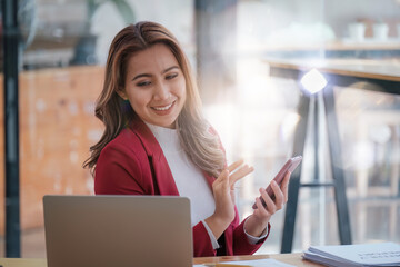 Fototapeta premium Portrait of Smiling asian business woman with laptop computer in office. Woman in suit at office