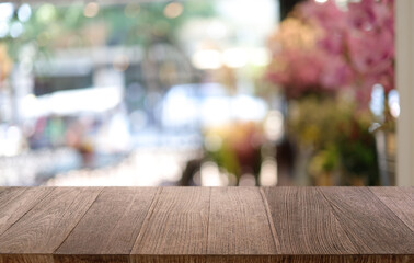 Empty wooden table in front of abstract blurred background of coffee shop . can be used for display or montage your products.Mock up for display of product