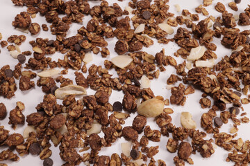 Background, texture of granola with oat, fruits, nuts and chocolate