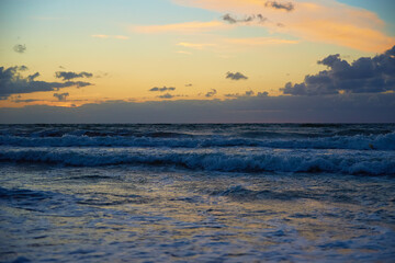 Obraz premium Panoramic view of sea landscape against sunset. Baltic sea coastline with waves and beautiful cloudy sky