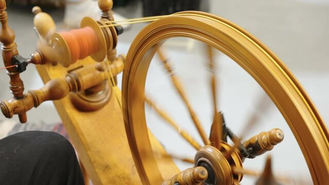 The spinning wheel with the red thread on it inside a room in Estonia