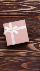 Present box on wooden background, copy space