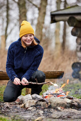 danish girl in nature roasting marshmallow