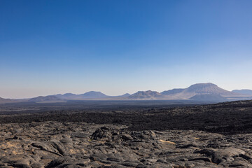 Views across the black lava volcano field of Jabal Qidr in the Harrat Khaybar region, north west Saudi Arabia © hyserb