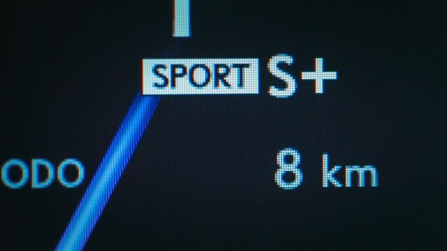 Switching between sport and eco mode drive on a digital control panel screen of electric car's dashboard panel. Green and blue pixels with text letters