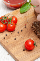 Abstract wooden background with cherry tomatoes and peppercorns
