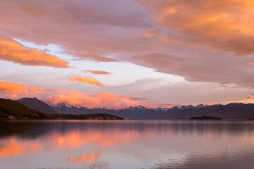 Sunrise over Lake Tekapo and snow capped mountains in New Zealand