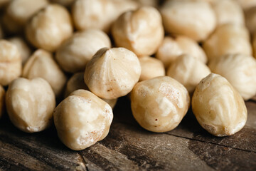 Background of peeled hazelnuts close-up, macro shot.
