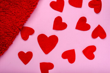 Heart-shaped felt figures on a pink background. Valentine's Day background.